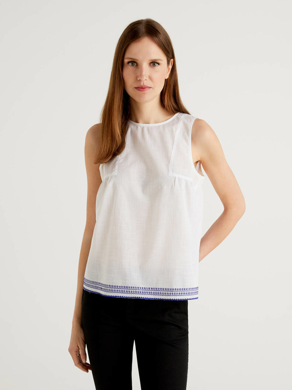 Sleeveless top with embroidered bottom